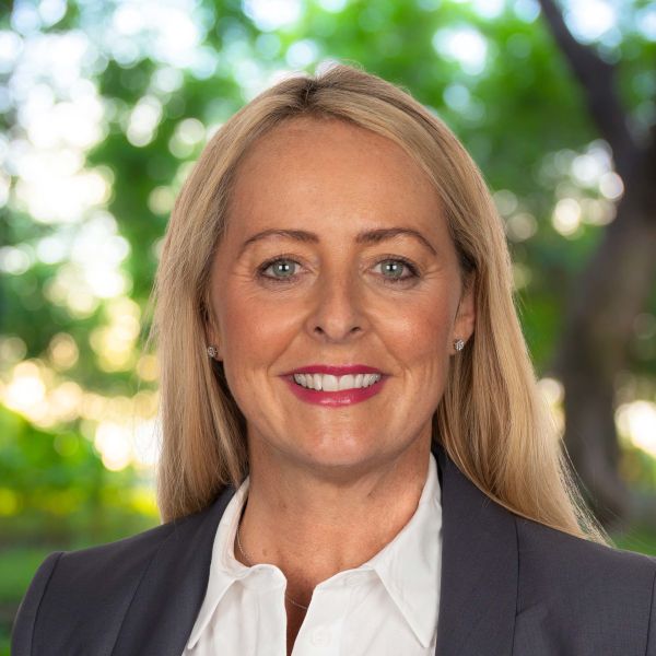 Smiling woman in suit with green background